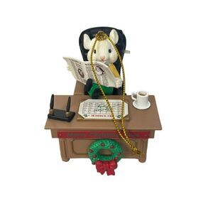 Mouse at a desk reading newspaper "Merry Christmas Boss"